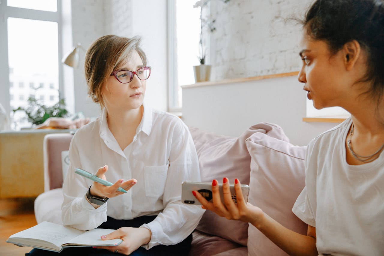 gallery-2 Therapist and client discussing mental health issues during a counseling session in a bright, cozy room.